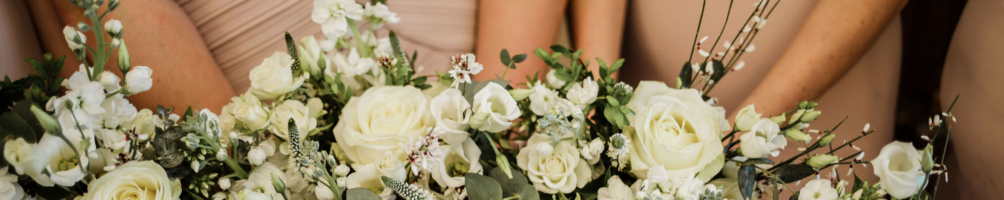 Bridesmaids holding wedding flowers in Whitchurch