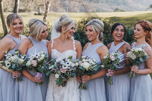 Bride and bridesmaids holding bouquets