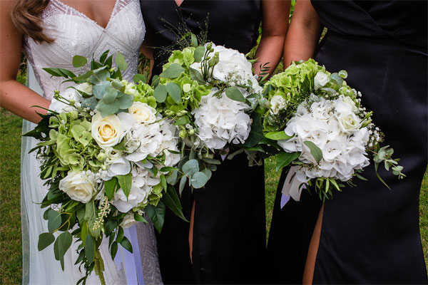 Bride with bridesmaids holding flowers